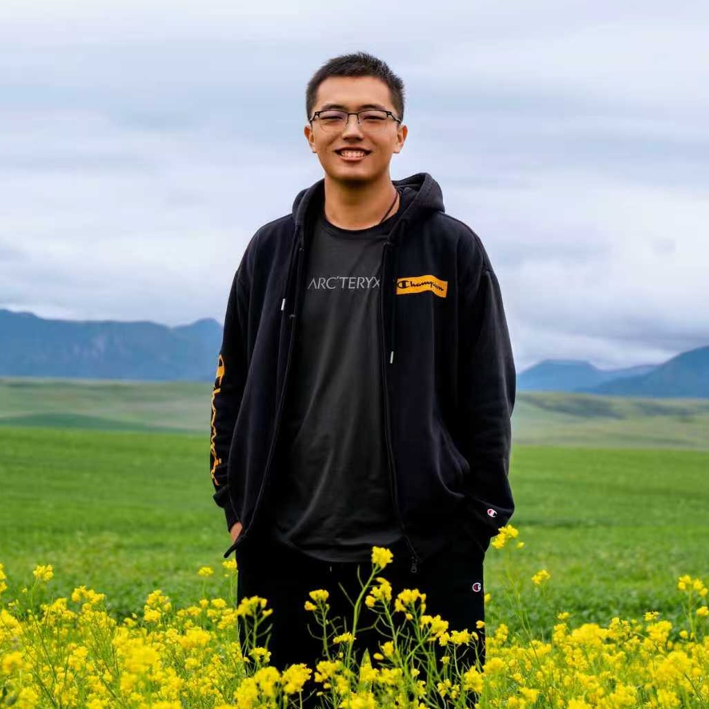Yuchen Zhou outdoors in a field of yellow flowers.